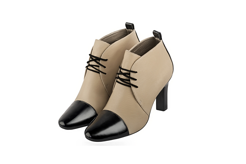 Women's gloss black and egg shell beige elegant ankle boots, with laces at the front. Round toe. High kitten heels - Front view